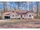 Charming ranch home with a tan exterior, wreaths on the windows, and an attached two car garage at 9224 Snipe Ln, Jonesboro, GA 30236