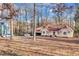 Scenic view of the front of this tan home with a two-car garage and a leaf-covered yard at 9224 Snipe Ln, Jonesboro, GA 30236