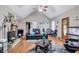 Bright and airy living room featuring hardwood floors, a cozy fireplace adorned with holiday decor, and comfortable leather furniture at 9224 Snipe Ln, Jonesboro, GA 30236