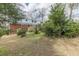 The backyard features a red brick house with lots of vegetation growing around it at 3390 Somerset Sw Trl, Atlanta, GA 30331