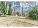 Expansive backyard with tall trees and storage shed, creating a private, serene outdoor setting at 3390 Somerset Sw Trl, Atlanta, GA 30331