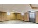 Partially finished basement with paneled walls and a back door at 3390 Somerset Sw Trl, Atlanta, GA 30331