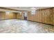 Partially finished basement with paneled walls and colorful tile flooring at 3390 Somerset Sw Trl, Atlanta, GA 30331