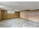 Partially finished basement with paneled walls, drop ceiling and small windows at 3390 Somerset Sw Trl, Atlanta, GA 30331