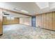 Spacious basement area featuring paneled walls and unique tile flooring at 3390 Somerset Sw Trl, Atlanta, GA 30331