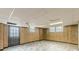 Partially finished basement featuring paneled walls, drop ceiling and exit door at 3390 Somerset Sw Trl, Atlanta, GA 30331