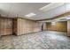 Spacious basement area with wood paneled walls, and a drop ceiling at 3390 Somerset Sw Trl, Atlanta, GA 30331