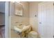 Bathroom featuring retro yellow tile, sink, toilet and white door at 3390 Somerset Sw Trl, Atlanta, GA 30331