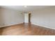 A vacant bedroom shows hardwood floors and leads to another room through a white door at 3390 Somerset Sw Trl, Atlanta, GA 30331