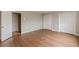 Spacious bedroom featuring hardwood floors and white closets and an open doorway to another room at 3390 Somerset Sw Trl, Atlanta, GA 30331