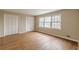 Spacious bedroom featuring gleaming hardwood floors, bright windows, and ample closet space at 3390 Somerset Sw Trl, Atlanta, GA 30331