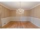 Elegant dining room featuring a chandelier and classic striped wallpaper at 3390 Somerset Sw Trl, Atlanta, GA 30331