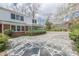 Backyard of the house with a decorative stone patio, sun room, and lots of space for activities at 3390 Somerset Sw Trl, Atlanta, GA 30331