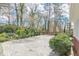 Rear of home with a stone patio, beautiful landscaping, and private outdoor living at 3390 Somerset Sw Trl, Atlanta, GA 30331