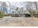 Spacious home featuring an attached garage and large driveway, offering ample parking space at 3390 Somerset Sw Trl, Atlanta, GA 30331
