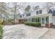 Rear exterior of home with large backyard stone patio, featuring a sunroom and lots of green space at 3390 Somerset Sw Trl, Atlanta, GA 30331