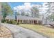 Ranch home featuring a front porch with white columns and well manicured lawn at 3390 Somerset Sw Trl, Atlanta, GA 30331