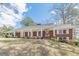 Beautiful brick ranch home featuring a welcoming porch with columns and manicured lawn at 3390 Somerset Sw Trl, Atlanta, GA 30331