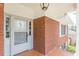 Inviting front door framed by brick and stylish tile at 3390 Somerset Sw Trl, Atlanta, GA 30331