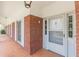 A traditional brick porch with white trim and tile flooring welcomes you home at 3390 Somerset Sw Trl, Atlanta, GA 30331