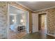 View of a hallway featuring floral wallpaper and doorways leading to a bedroom and bathroom at 3390 Somerset Sw Trl, Atlanta, GA 30331