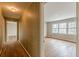 View of a hallway and an adjacent room featuring hardwood floors and a bright window at 3390 Somerset Sw Trl, Atlanta, GA 30331