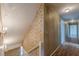 Hallway with wallpapered walls and wood floors; stairs lead down to the main level at 3390 Somerset Sw Trl, Atlanta, GA 30331