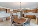 Eat-in kitchen with wood cabinets, tile floors, and chandelier at 3390 Somerset Sw Trl, Atlanta, GA 30331