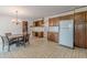 Eat-in kitchen with wood cabinets, tile floors, and chandelier at 3390 Somerset Sw Trl, Atlanta, GA 30331