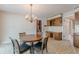 Eat-in kitchen with wood cabinets, tile floors, and chandelier at 3390 Somerset Sw Trl, Atlanta, GA 30331
