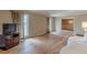 Living room featuring hardwood floors, two windows with curtains, and access to another room at 3390 Somerset Sw Trl, Atlanta, GA 30331
