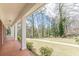 Covered porch overlooking lush lawn with mature trees, perfect for relaxation at 3390 Somerset Sw Trl, Atlanta, GA 30331