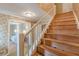 Wooden staircase with white railings and adjacent doorway showcasing home's layout at 3390 Somerset Sw Trl, Atlanta, GA 30331