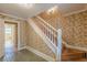 A staircase featuring floral wallpaper and doors leading to other rooms in the home at 3390 Somerset Sw Trl, Atlanta, GA 30331