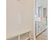 Mudroom with built-in bench and storage, leading to kitchen with sleek gray cabinetry and modern wood floor at 4212 Adler Cir, Buford, GA 30519