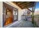 Outdoor patio with wooden deck, railing, and view of an interior doorway at 48 Peachtree Ne Ave # 412, Atlanta, GA 30305