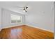 A sunny bedroom with hardwood floors and a ceiling fan at 48 Peachtree Ne Ave # 412, Atlanta, GA 30305