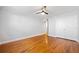 A neutral bedroom features hardwood floors and a ceiling fan at 48 Peachtree Ne Ave # 412, Atlanta, GA 30305