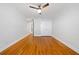 Bedroom showing a closet, doorway, hardwood floors, and ceiling fan at 48 Peachtree Ne Ave # 412, Atlanta, GA 30305