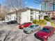 Apartment building exterior featuring parking spaces and small balconies at 48 Peachtree Ne Ave # 412, Atlanta, GA 30305