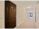 Hallway in front of brown apartment unit door 412 with carpeted floors at 48 Peachtree Ne Ave # 412, Atlanta, GA 30305