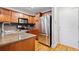 Bright kitchen featuring stainless steel appliances, wood cabinets, and granite counters at 48 Peachtree Ne Ave # 412, Atlanta, GA 30305