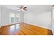 Bright living room with hardwood floors, ceiling fan and glass doors to a balcony at 48 Peachtree Ne Ave # 412, Atlanta, GA 30305