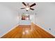 Open living room with hardwood floors flowing into kitchen with stainless steel appliances at 48 Peachtree Ne Ave # 412, Atlanta, GA 30305