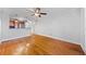 Open living room with hardwood floors flowing into kitchen with stainless steel appliances at 48 Peachtree Ne Ave # 412, Atlanta, GA 30305