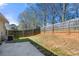 Spacious backyard featuring a concrete patio area and a wooden fence for privacy and outdoor enjoyment at 6450 Wellington Chase Ct, Lithonia, GA 30058