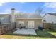The backyard shows a concrete patio, lawn, and wood fence, creating a cozy outdoor retreat at 6450 Wellington Chase Ct, Lithonia, GA 30058