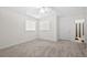 Bedroom featuring neutral carpet, a window and a door leading to a connected bathroom at 6450 Wellington Chase Ct, Lithonia, GA 30058