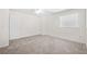 Bright and spacious bedroom with a window, white walls and neutral carpet flooring at 6450 Wellington Chase Ct, Lithonia, GA 30058