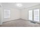 Cozy bedroom with plush carpet, French doors and natural light from large window at 6450 Wellington Chase Ct, Lithonia, GA 30058